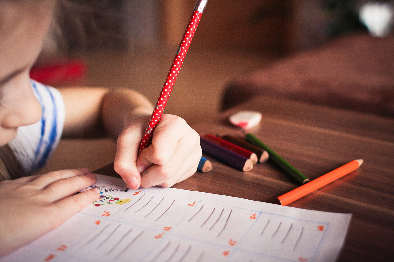 Photo of kid working on a paper. Image by free stock photos from www.picjumbo.com from Pixabay